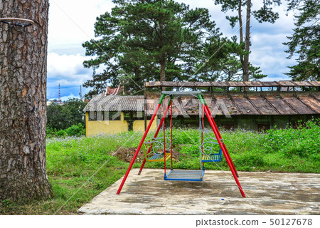 Empty chain swings in playground outdoors Empty chain swings in playground outdoors 50127678