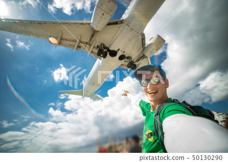 Huge plane over man's head during he taking selfie on the Maho beach Huge plane over man's head during he taking selfie on the Maho beach 50130290