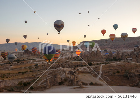 Hot air balloons flying over landscape Cappadocia 50131446