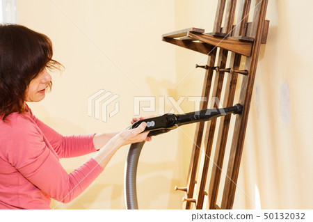 Woman cleaning dust on hanger 50132032