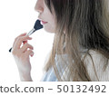 Woman doing make-up 50132492