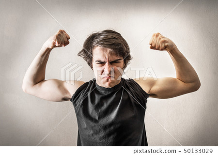Angry teenager showing muscles 50133029