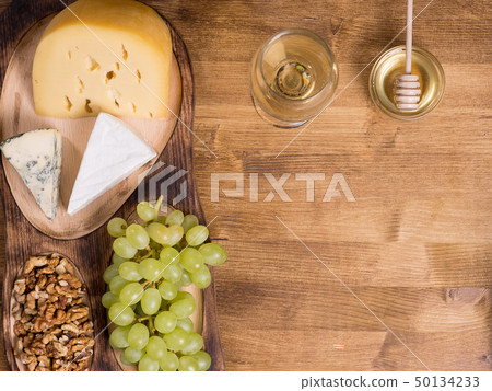 Grapes, white wine. honey and nuts over rustic wooden table Grapes, white wine. honey and nuts over rustic wooden table 50134233