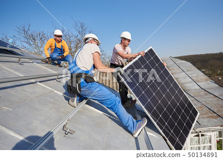 Installing solar photovoltaic panel system on roof of house Installing solar photovoltaic panel system on roof of house 50134891