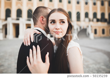 Caucasian happy romantic young couple celebrating their marriage. Outdoor Caucasian happy romantic young couple celebrating their marriage. Outdoor 50135239