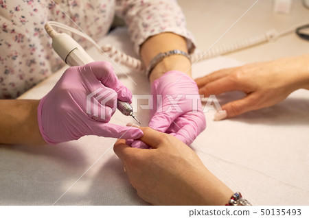 Hardware manicure .Hands of an adult woman. Age manicure 50135493