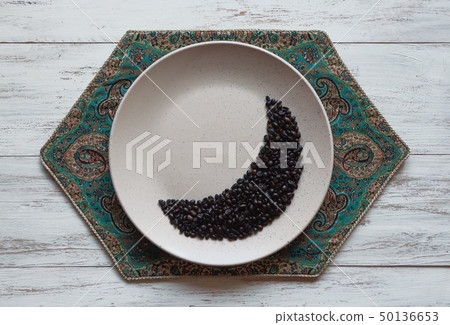 Coffee beans in moon shape on a plate. 50136653