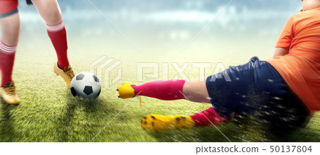Football player woman in orange jersey sliding Football player woman in orange jersey sliding 50137804