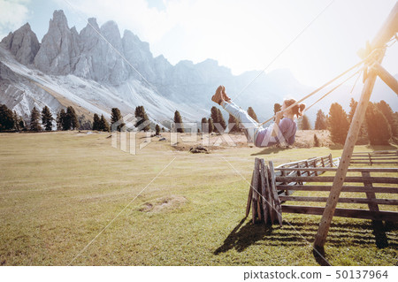 Girls ride on a swing 50137964