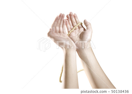 Muslim hands praying with prayer beads Muslim hands praying with prayer beads 50138436
