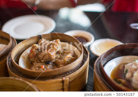 Chinese dim sum in a bamboo steamer box 50143187
