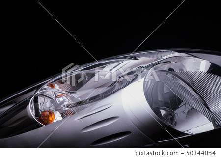 a car headlight on a black background a car headlight on a black background 50144034