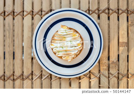 Homemade lemon tart decorated with meringue swirls Homemade lemon tart decorated with meringue swirls 50144147