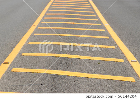 Yellow color road line on asphalt background Yellow color road line on asphalt background 50144204