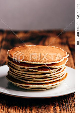 Stack of american pancakes on white plate 50144288
