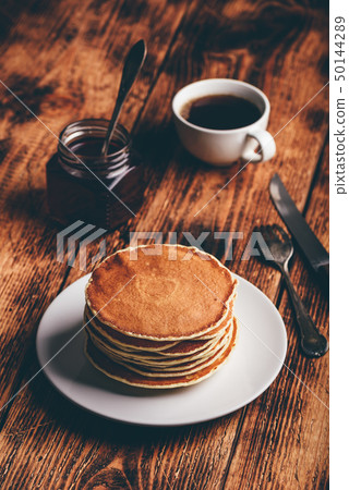 Stack of pancakes on white plate 50144289
