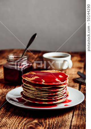 Stack of pancakes with berry jam 50144290