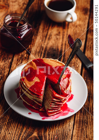 Stack of pancakes with berry jam 50144291