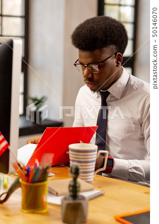 Smart young office worker doing his job Smart young office worker doing his job 50146070