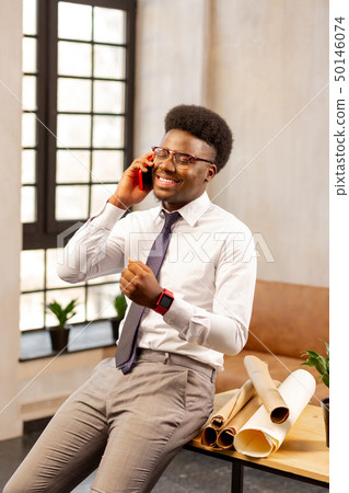 Positive cheerful man speaking with his client Positive cheerful man speaking with his client 50146074