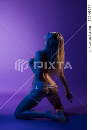 Nude girl wrapped in transparent film shot 50146953