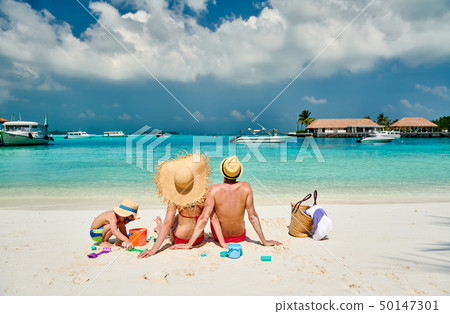 Family with three year old boy on beach 50147301