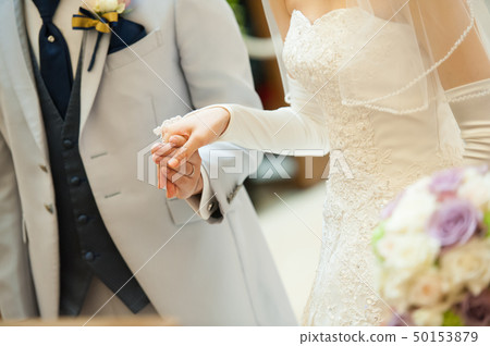 A groom that escorts a bride 50153879