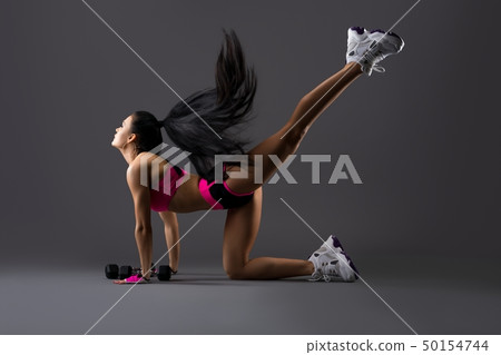 Gorgeous fitness trainer in pink sportswear shot 50154744