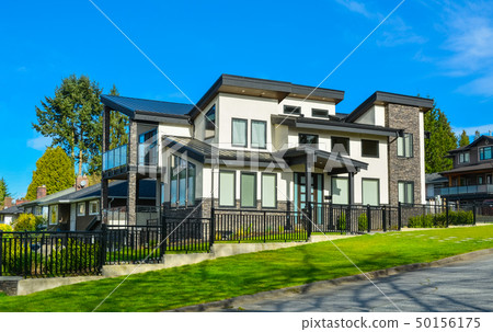 New residential house with concrete tile pathway over front lawn New residential house with concrete tile pathway over front lawn 50156175
