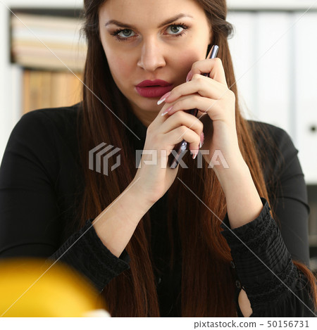 Beautiful brunette smiling businesswoman hold in arm cellphone 50156731