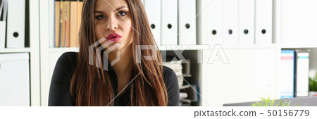 Beautiful smiling clerk girl at workplace talk to visitor Beautiful smiling clerk girl at workplace talk to visitor 50156779