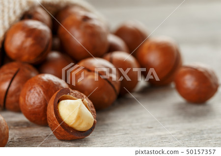 Macadamia nut on a wooden table in a bag, closeup, Macadamia nut on a wooden table in a bag, closeup, 50157357