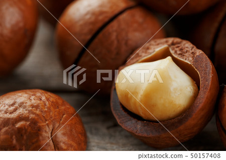 Macadamia nut on a wooden table in a bag, closeup, Macadamia nut on a wooden table in a bag, closeup, 50157408