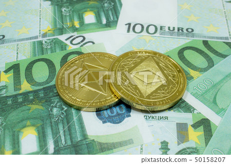Close-up of 2 Ethereum coins on 100 Euro banknotes. Crypto currency ETC. Close-up of 2 Ethereum coins on 100 Euro banknotes. Crypto currency ETC. 50158207
