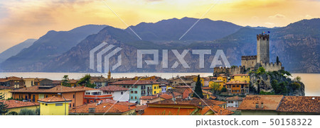 italian village skyline of Malcesine peaceful panoramic town on Garda Lake waterfront romantic italian village skyline of Malcesine peaceful panoramic town on Garda Lake waterfront romantic 50158322