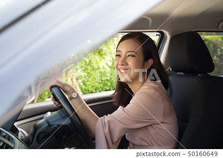 Asian women driving a car and smile happily Asian women driving a car and smile happily 50160649