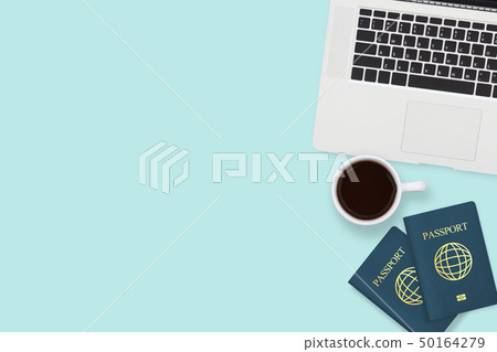 flat lay of two passport , coffee cup and computer 50164279