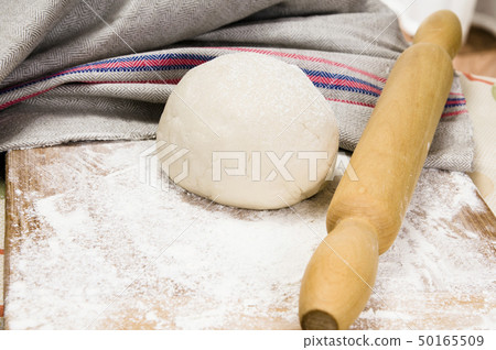 fresh raw dough and rolling pin fresh raw dough and rolling pin 50165509