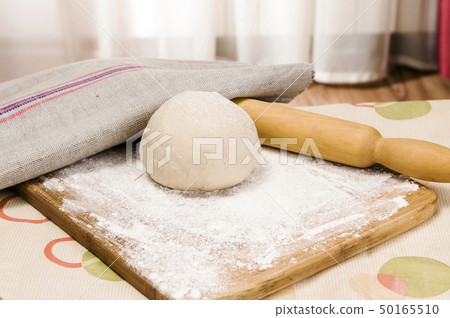 fresh raw dough and rolling pin fresh raw dough and rolling pin 50165510