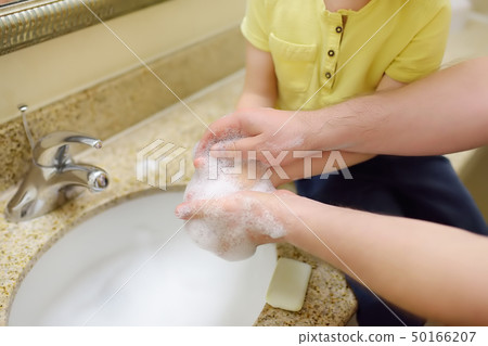 Little boy and his father washing their hands Little boy and his father washing their hands 50166207