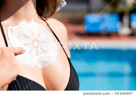 Beautiful woman has a sunscreen in sun shape on Beautiful woman has a sunscreen in sun shape on 50166997