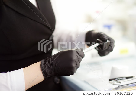 Beautician sharpening a pencil Beautician sharpening a pencil 50167129