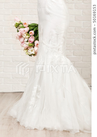 Wedding bouquet of tulips in bride's hands 50169153
