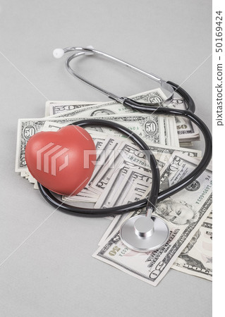Stethoscope and red heart on American Dollars Stethoscope and red heart on American Dollars 50169424