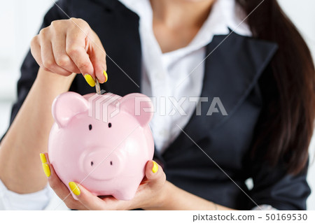 Piggy bank and woman 50169530