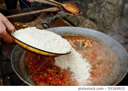 man preparing a typical spanish paella man preparing a typical spanish paella 50169935