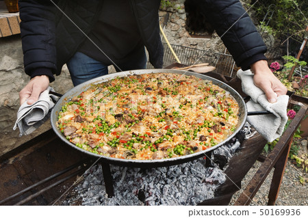 man with a typical spanish paella man with a typical spanish paella 50169936