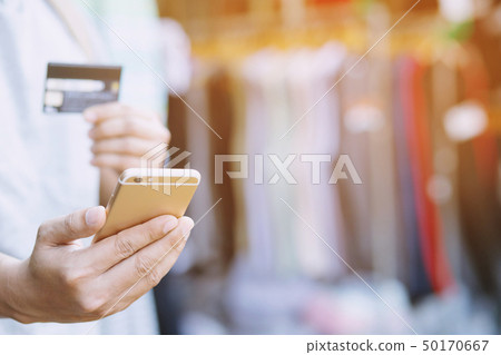 young male hands holding credit card young male hands holding credit card 50170667