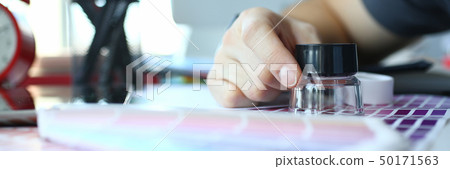 Male serviceman hold in hand magnifying glass making colour test 50171563