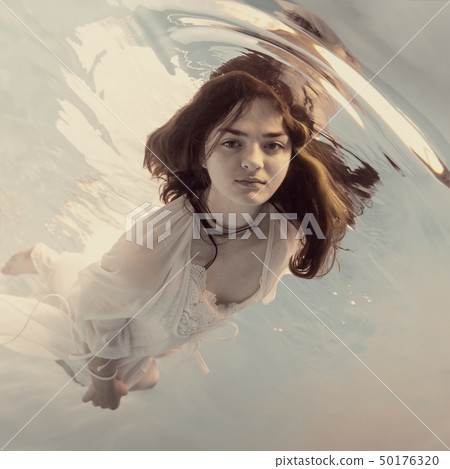 Portrait of a girl in a white dress under water Portrait of a girl in a white dress under water 50176320